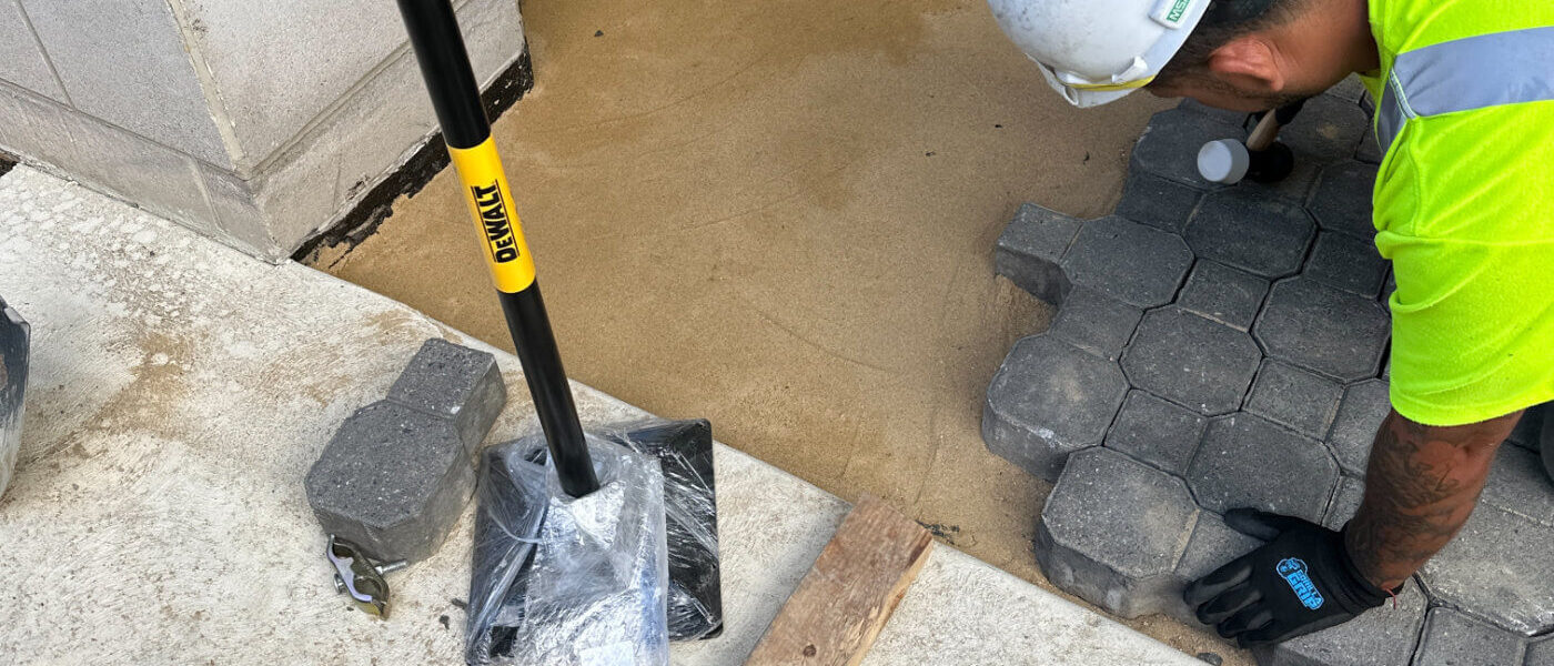 ShanCon employee with a jack hammer working on concrete repair and restoration